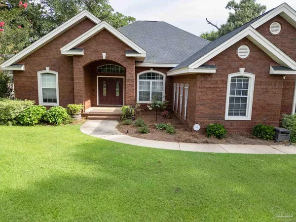 a front view of a house with a yard and porch