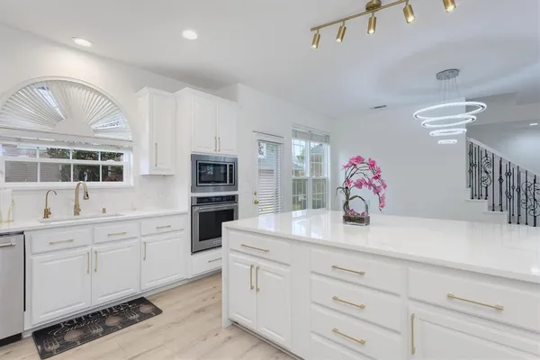 a kitchen with cabinets a sink and appliances