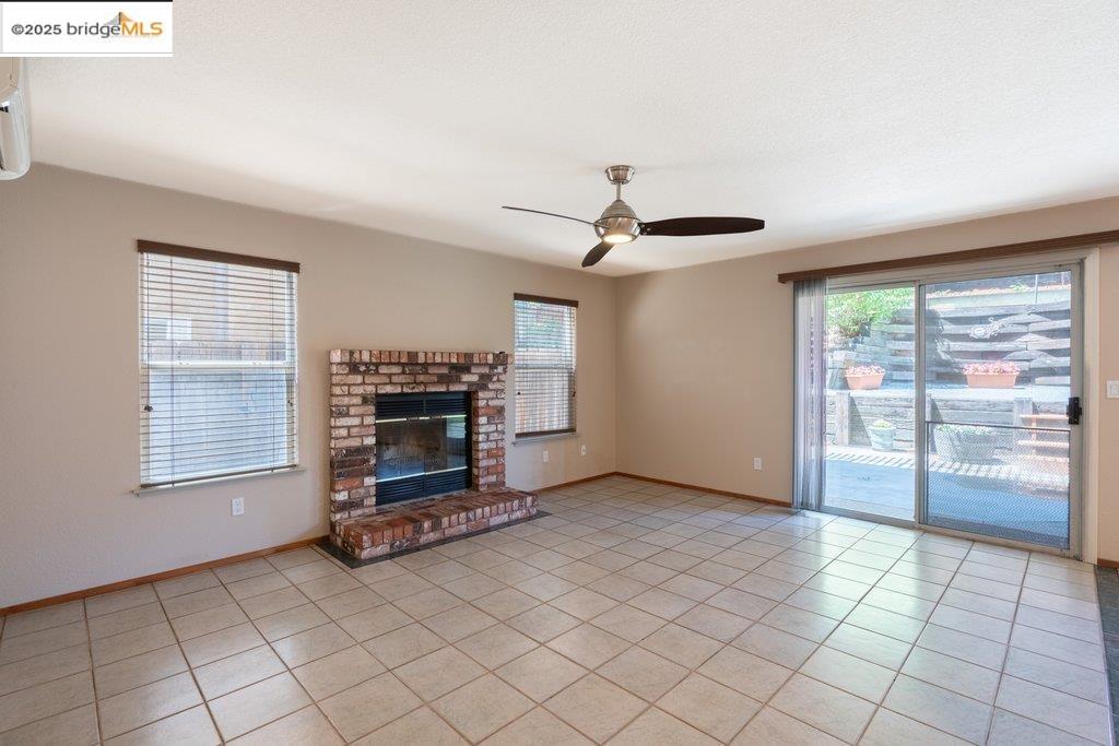 1003 Linda Vista Way Rio Vista, CA 94571 - Photo 23 of 60 Unfurnished living room with light tile patterned floors, healthy amount of natural light, and a fireplace