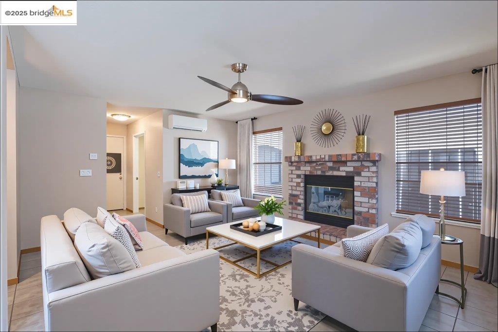 1003 Linda Vista Way Rio Vista, CA 94571 - Photo 25 of 60 Living room featuring a brick fireplace, light tile patterned flooring, a ceiling fan, and a wall mounted AC