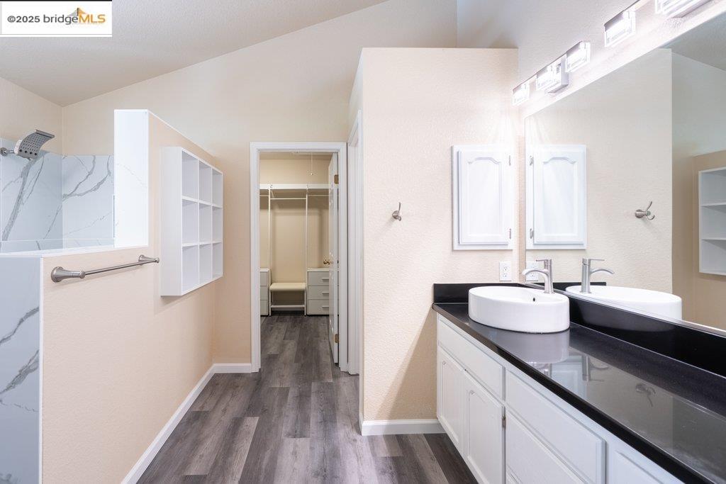 1003 Linda Vista Way Rio Vista, CA 94571 - Photo 33 of 60 Bathroom featuring double vanity, wood finished floors, a walk in closet, and a shower