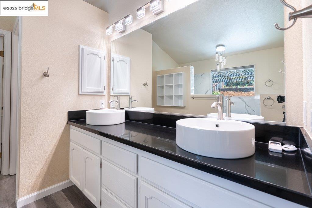 1003 Linda Vista Way Rio Vista, CA 94571 - Photo 34 of 60 Bathroom with a textured wall, double vanity, and wood finished floors
