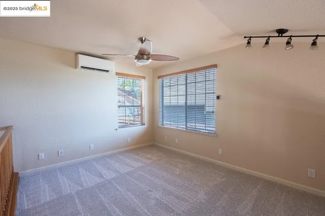 a front view of a house with a garden and trees