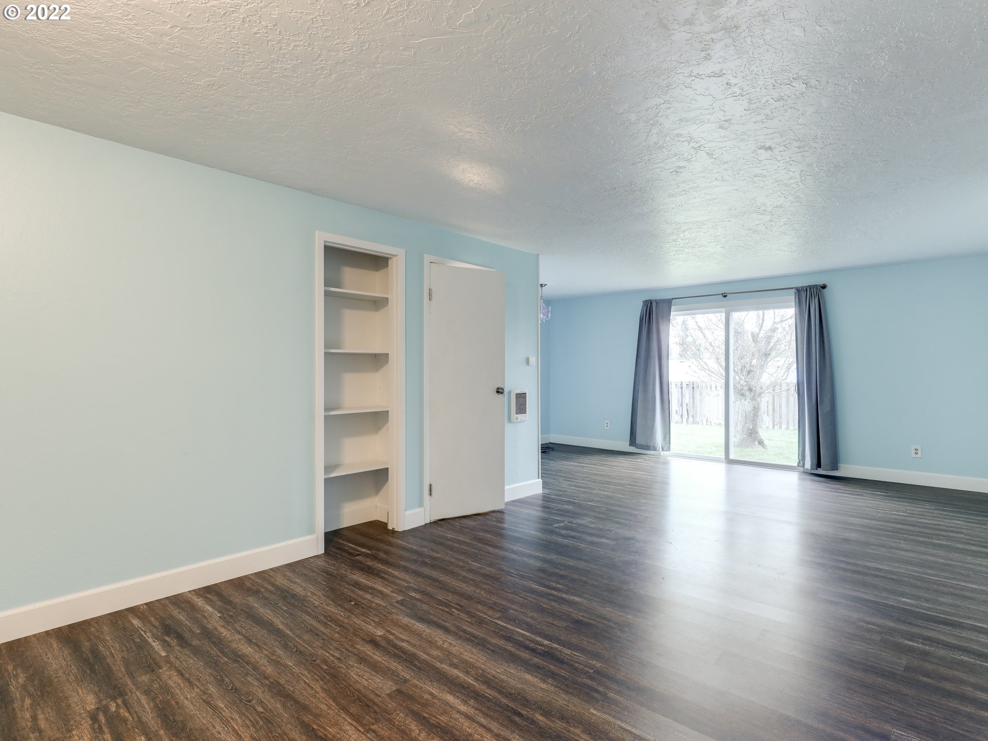 1902 Southeast 151st Avenue Portland, OR 97233 - Photo 16 of 30 a view of an empty room with wooden floor and window