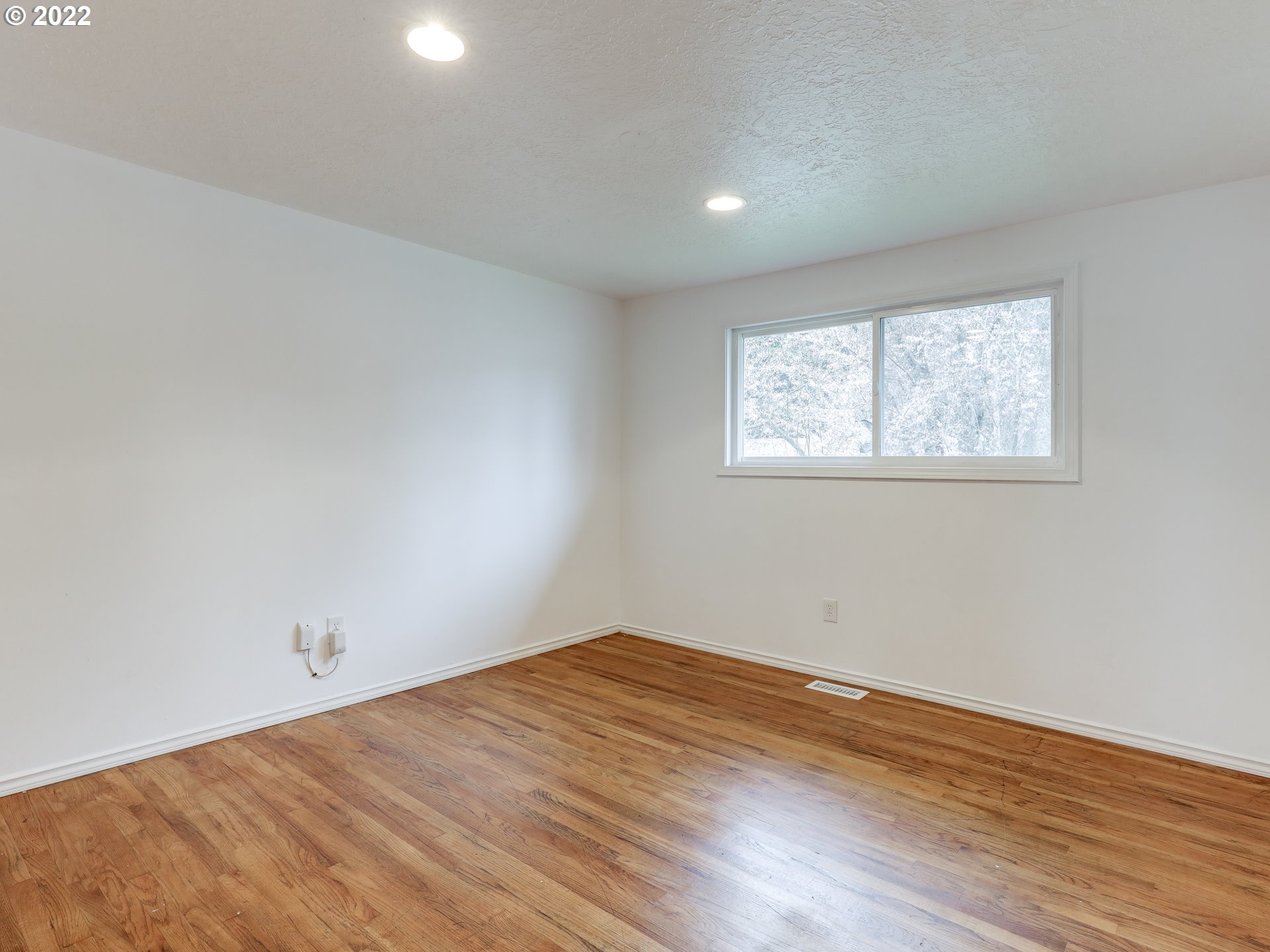 1902 Southeast 151st Avenue Portland, OR 97233 - Photo 18 of 30 an empty room with wooden floor and windows