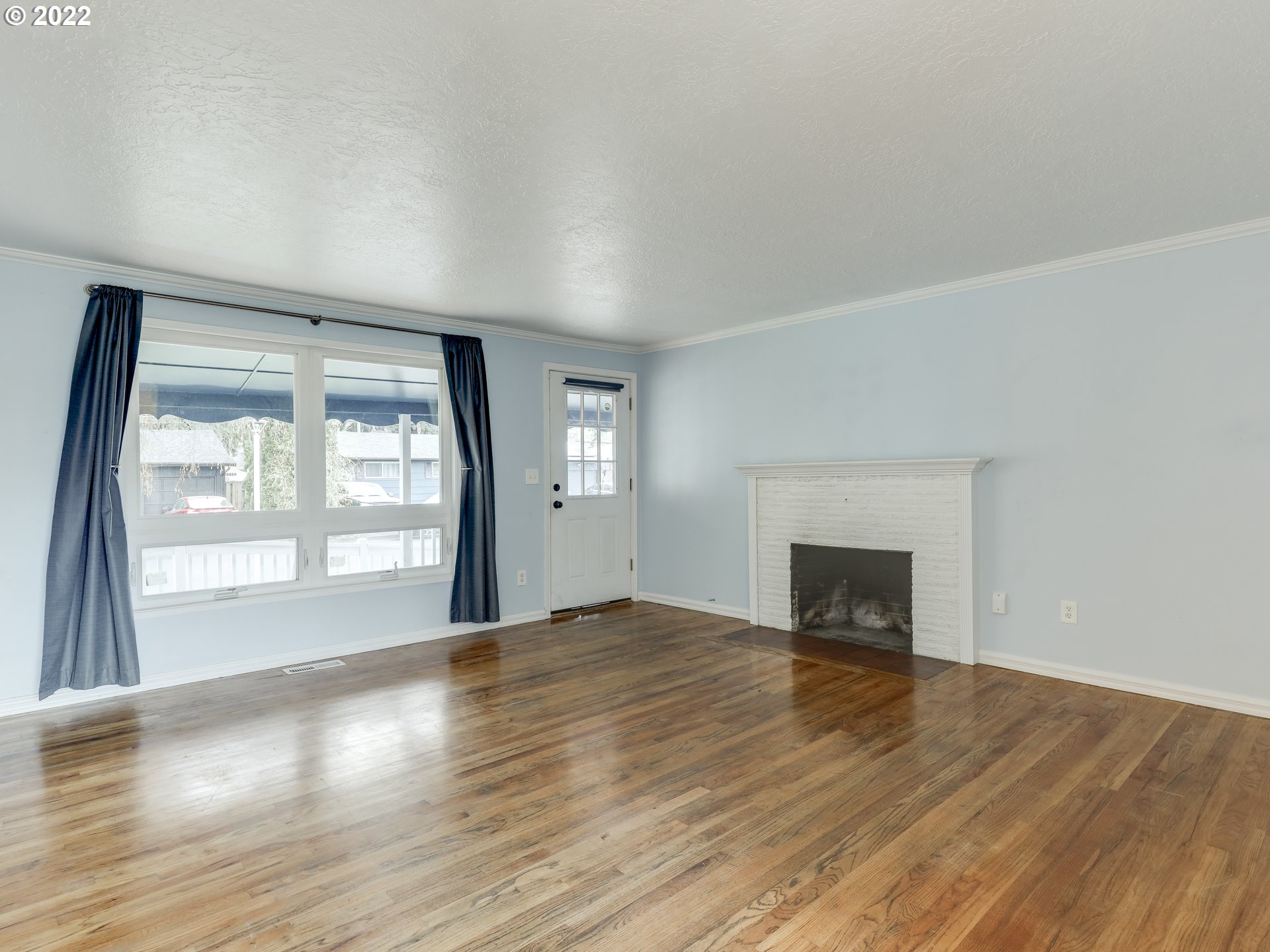 1902 Southeast 151st Avenue Portland, OR 97233 - Photo 6 of 30 an empty room with wooden floor and windows