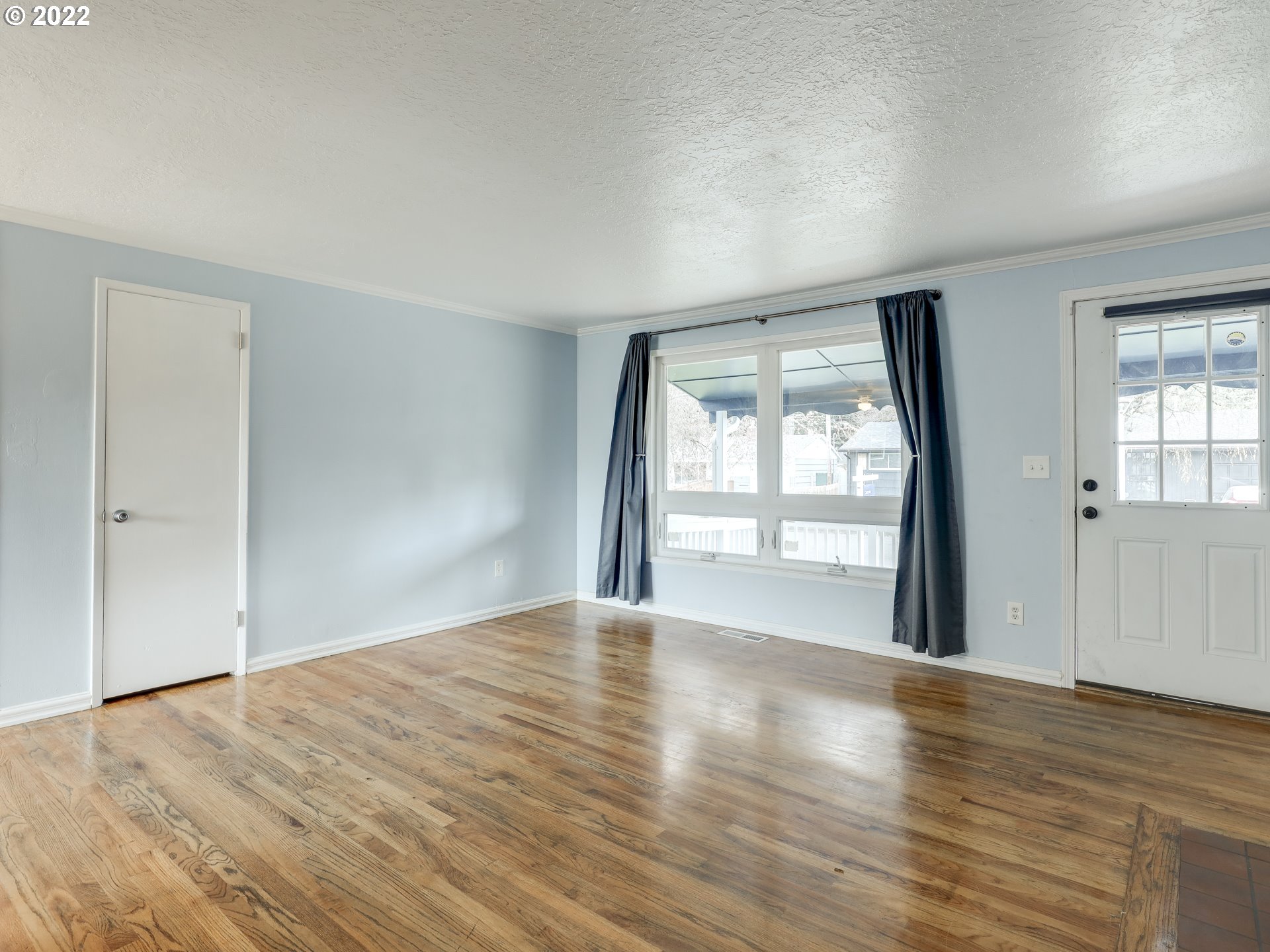 1902 Southeast 151st Avenue Portland, OR 97233 - Photo 7 of 30 wooden floor in an empty room with a window