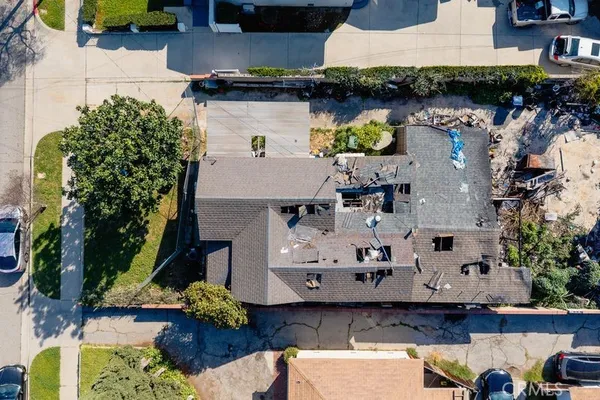 an aerial view of a house with swimming pool and outdoor seating