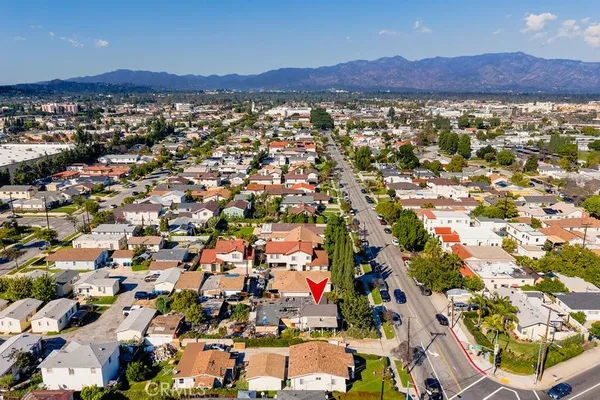 an aerial view of residential house and car parked