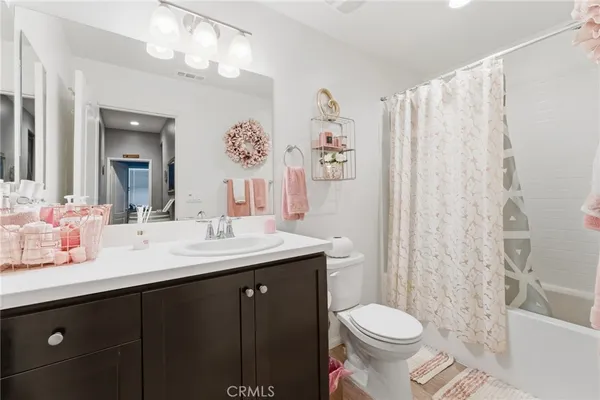 a white toilet sitting next to a shower curtain