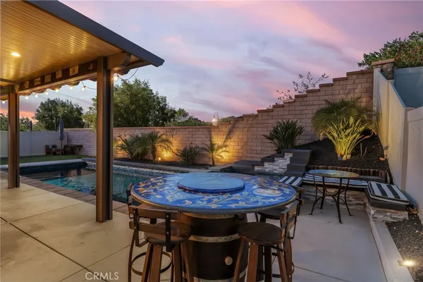 a kitchen with stainless steel appliances kitchen island granite countertop a sink a refrigerator and a stove