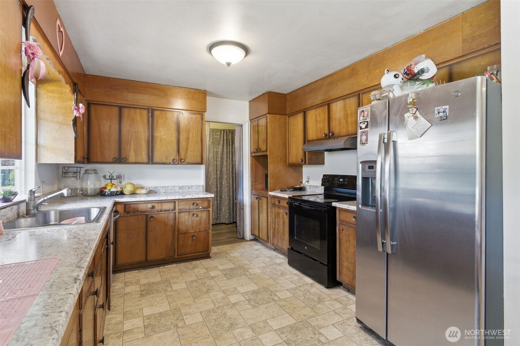 3017 Galvin Road, Unit A Centralia, WA 98531 - Photo 9 of 39 a large kitchen with a refrigerator sink and stainless steel appliances