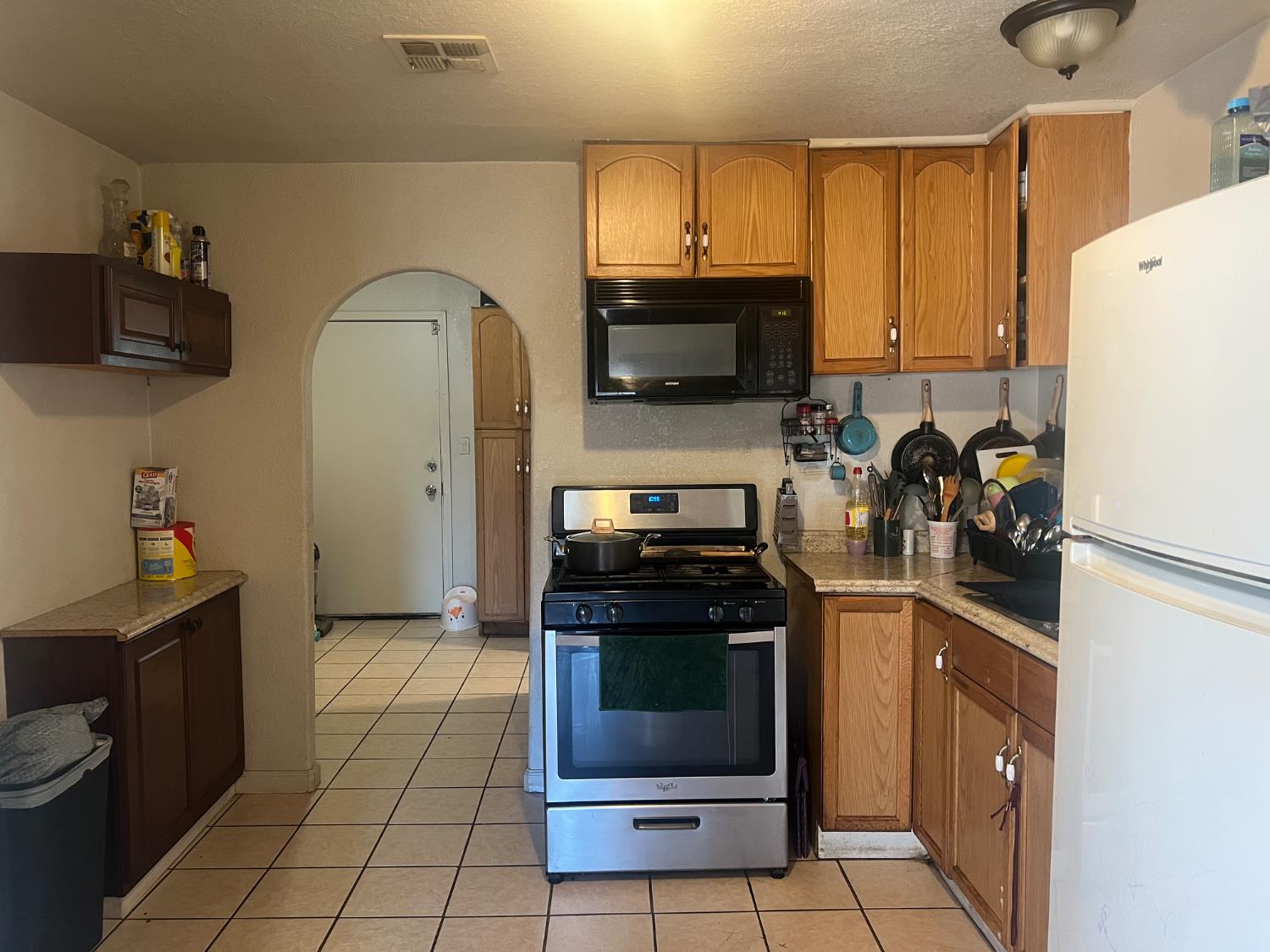 1514 Eureka Street Modesto, CA 95358 - Photo 3 of 14 a kitchen with a sink a stove and refrigerator