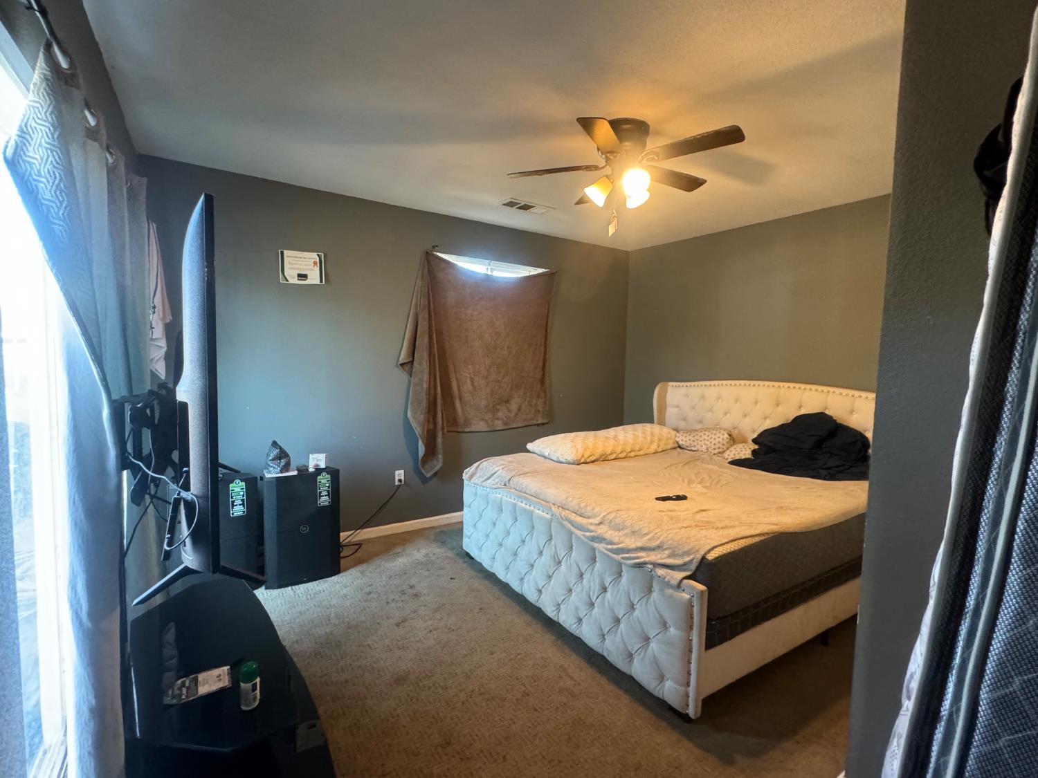 1514 Eureka Street Modesto, CA 95358 - Photo 10 of 14 a bedroom with a bed and a chandelier