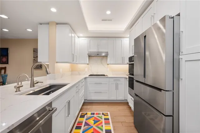 a kitchen with a sink appliances and cabinets