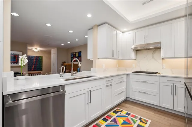 a kitchen with a sink window and cabinets