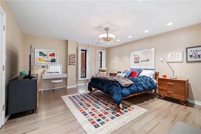 a bedroom with furniture and a chandelier