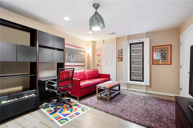 a living room with furniture a rug and a chandelier