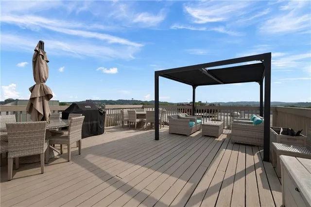 a view of roof deck with dining table and chairs