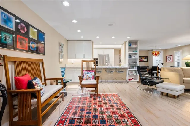 a living room with furniture flat screen tv and wall paintings