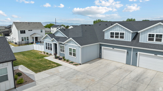 531 North Legend Way West, Unit D Mapleton, UT 84664 - Photo 40 of 42 View of front facade featuring a shingled roof, board and batten siding, concrete driveway, an attached garage, and a residential view