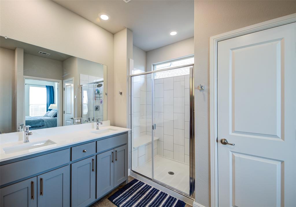 145 Hawksbill Lane Rhome, TX 76078 - Photo 12 of 23 a bathroom with a shower sink and mirror