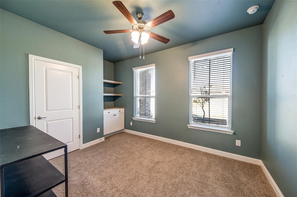 145 Hawksbill Lane Rhome, TX 76078 - Photo 13 of 23 an empty room with windows and cabinet
