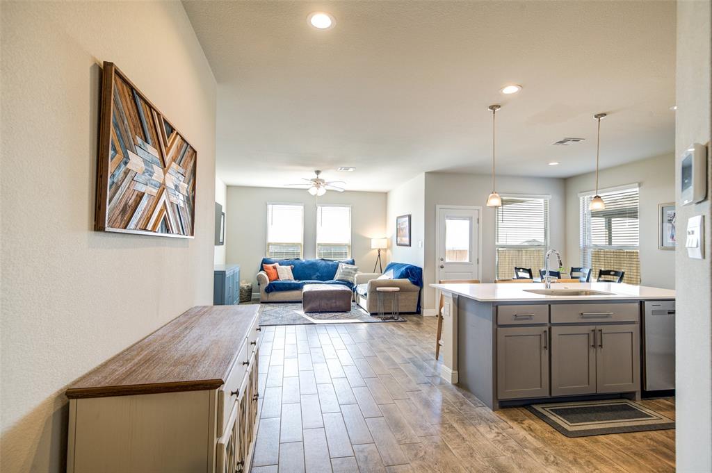 145 Hawksbill Lane Rhome, TX 76078 - Photo 3 of 23 a living room with stainless steel appliances furniture a rug and a kitchen view