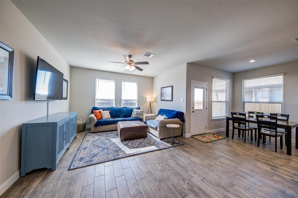 145 Hawksbill Lane Rhome, TX 76078 - Photo 4 of 23 a living room with fireplace furniture and a wooden floor