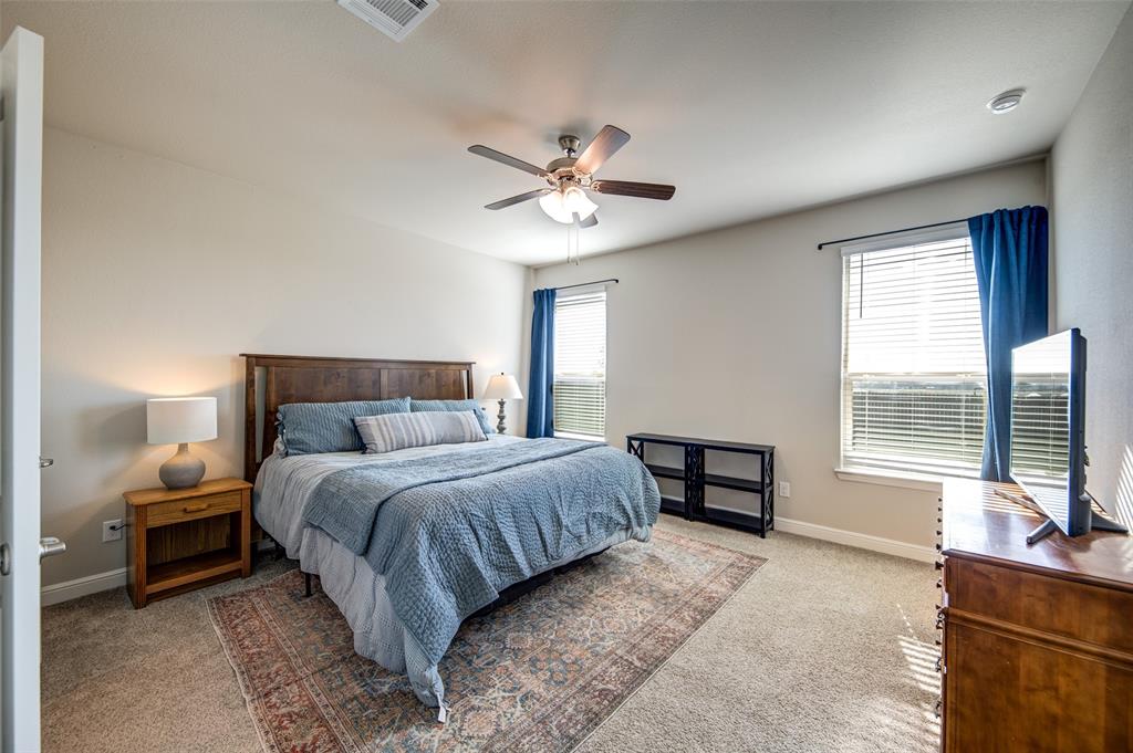 145 Hawksbill Lane Rhome, TX 76078 - Photo 10 of 23 a bedroom with a bed and a large window with balcony view