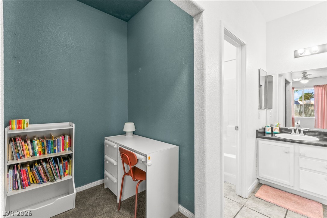 7353 Ridge Star Court Las Vegas, NV 89131 - Photo 25 of 36 An inviting study corner transitions seamlessly into a well-appointed primary bathroom, offering both utility and comfort.