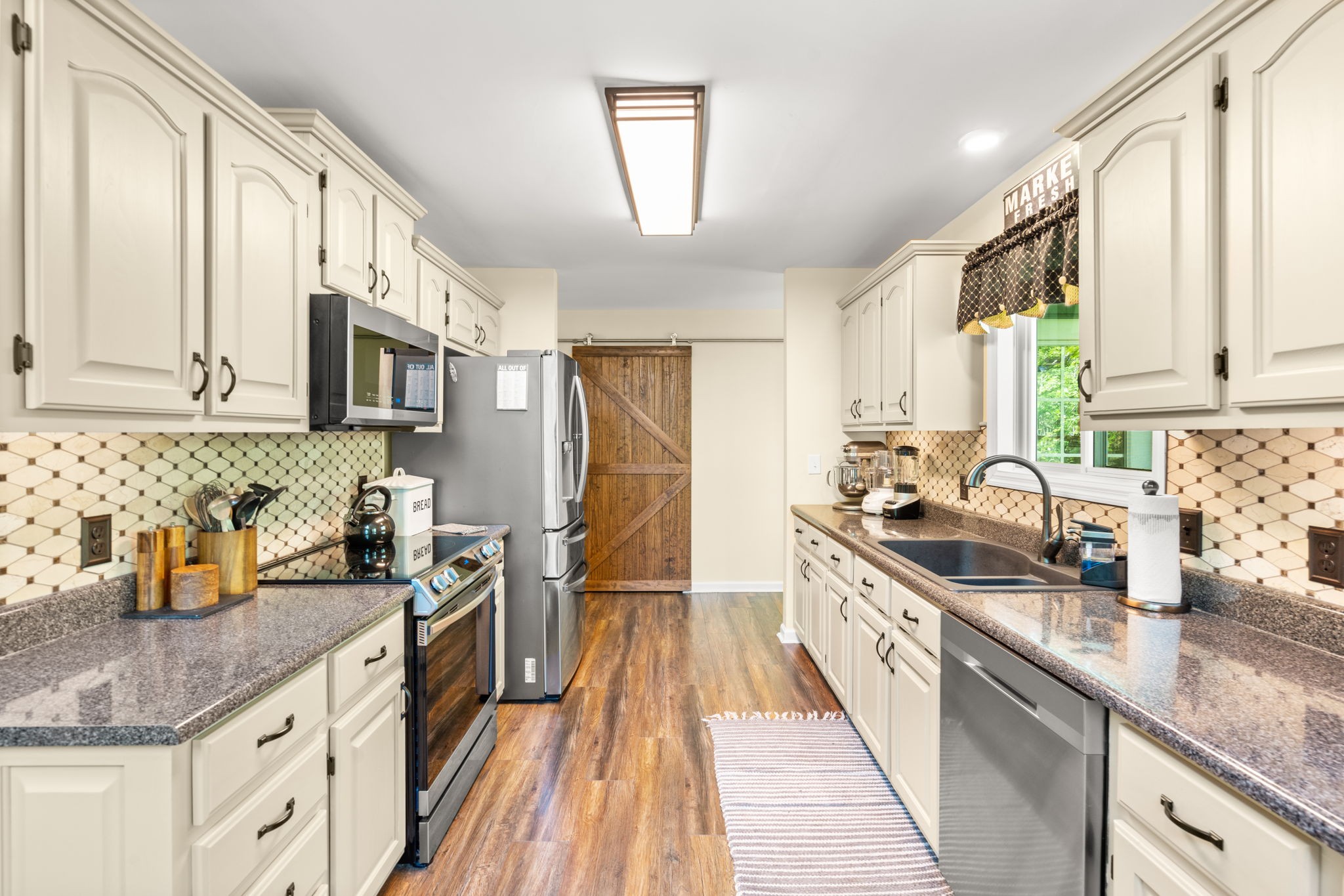 3779 Raleigh-Elam Road Santa Fe, TN 38482 - Photo 12 of 63 a kitchen with stainless steel appliances granite countertop a sink stove and refrigerator