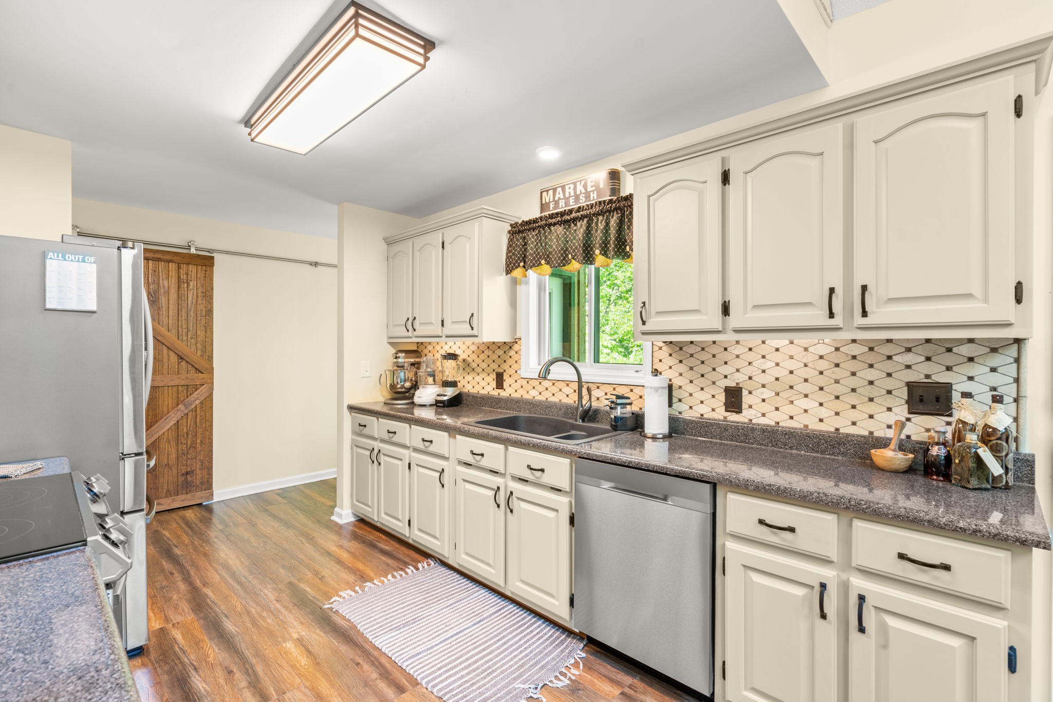 3779 Raleigh-Elam Road Santa Fe, TN 38482 - Photo 13 of 63 a kitchen with a sink dishwasher a refrigerator and cabinets