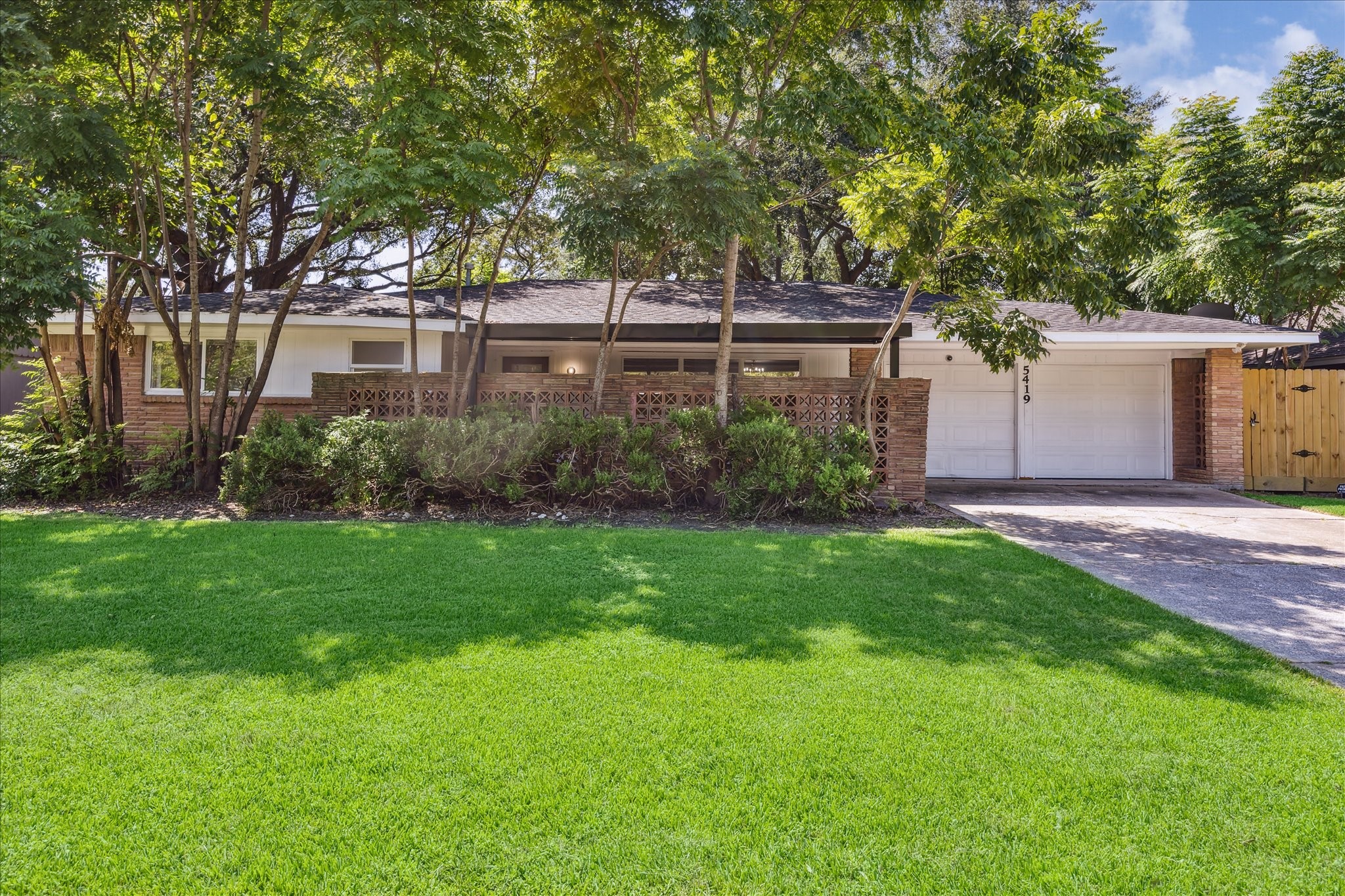 Welcome home to 5419 Beechnut St, an inviting one-story ranch style home featuring a wide driveway, mature trees, and a spacious front lawn.