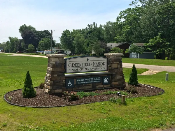 a view of a park with a sign board