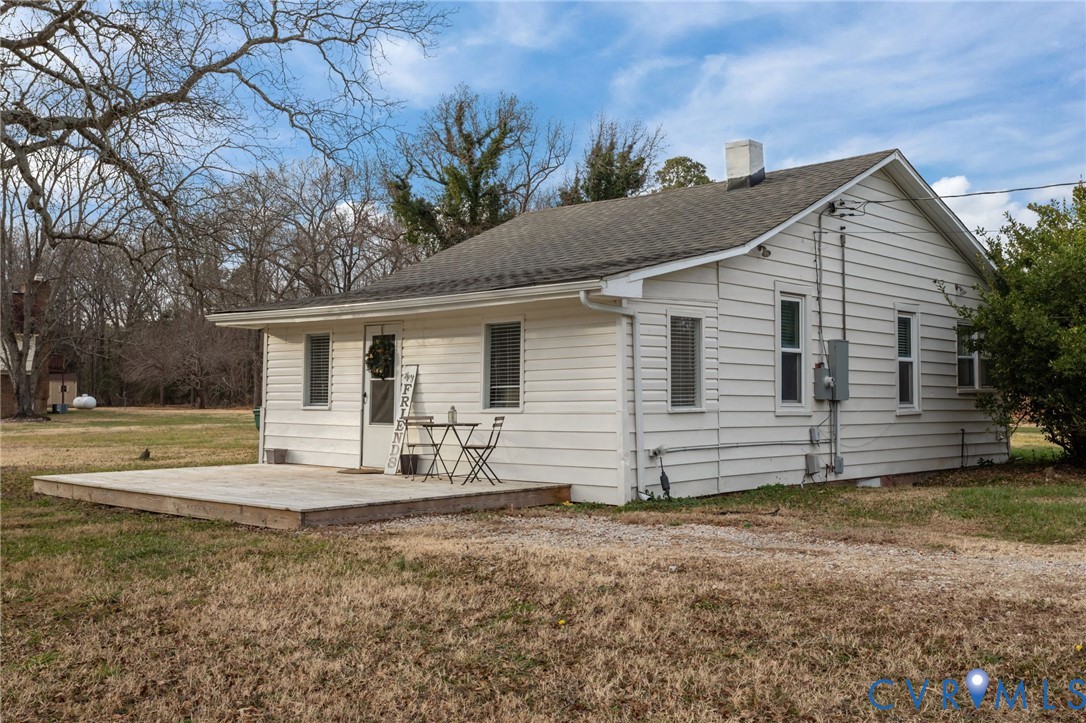 a view of a house with backyard and chairs