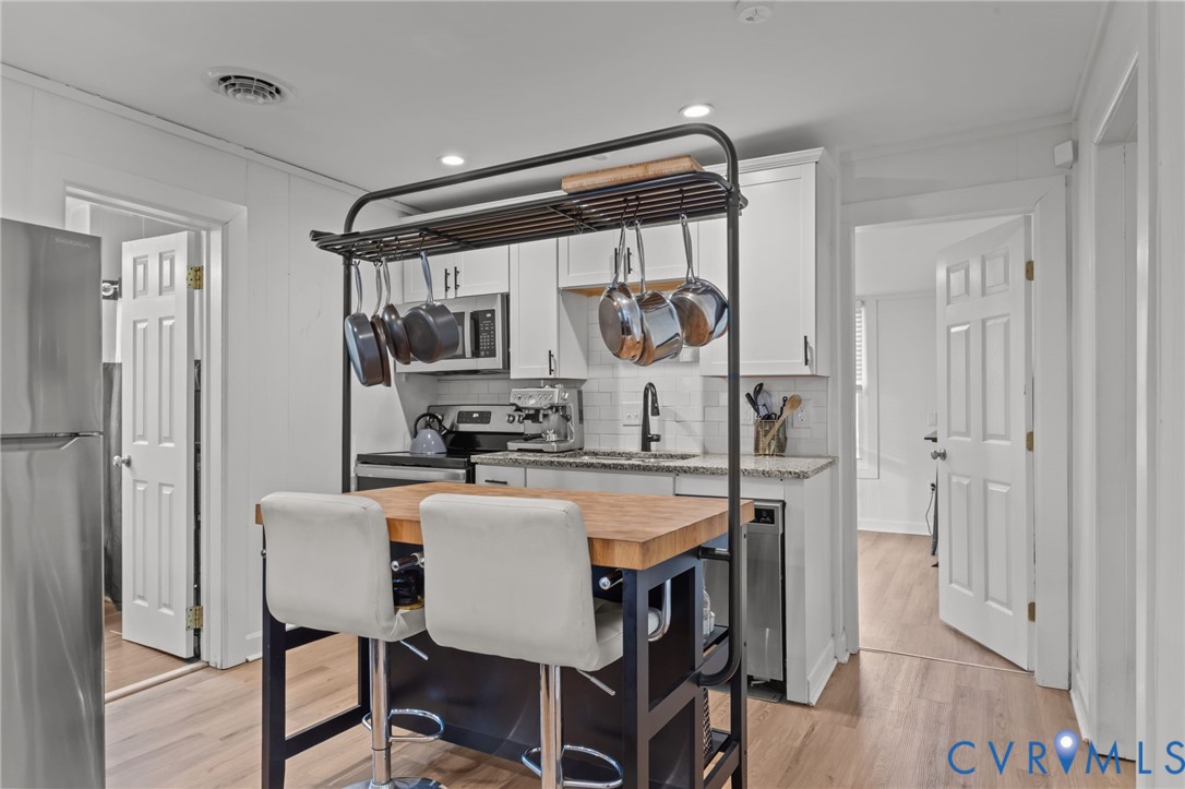8874 Strath Road Henrico, VA 23231 - Photo 12 of 40 a view of a dining room with furniture and wooden floor