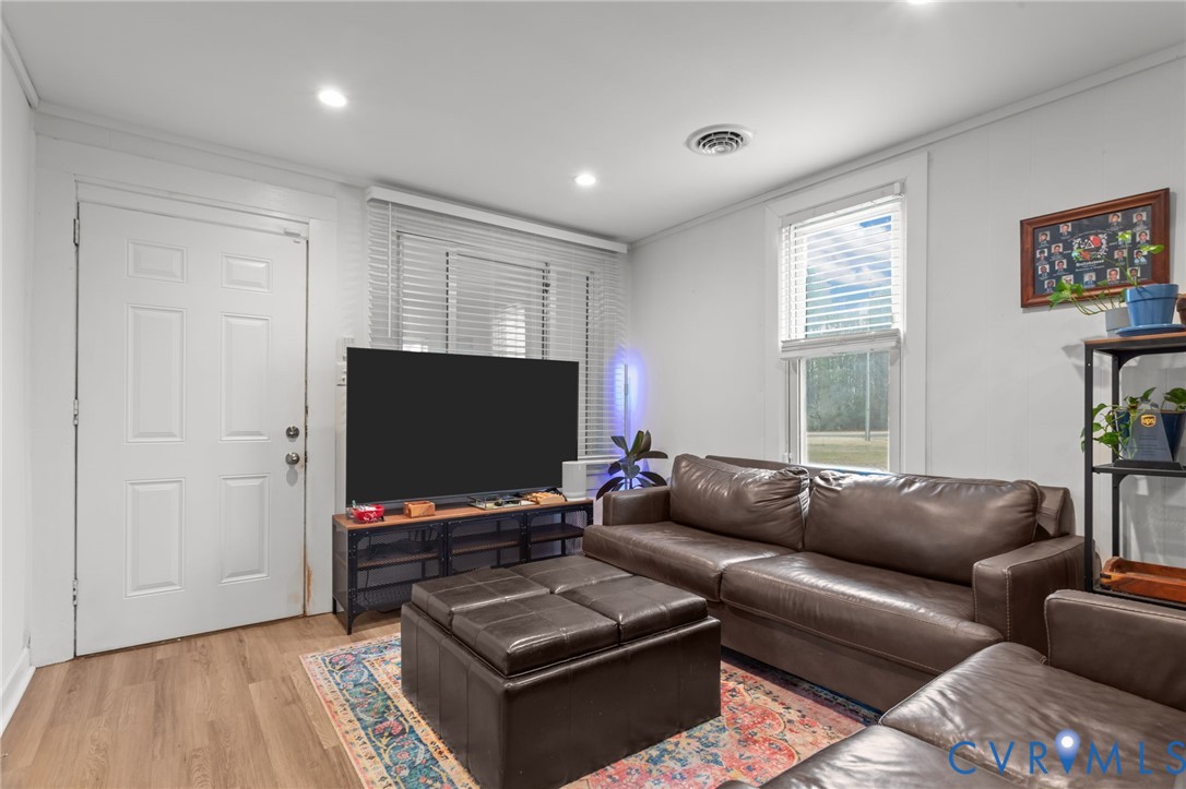 8874 Strath Road Henrico, VA 23231 - Photo 4 of 40 a living room with furniture and a flat screen tv