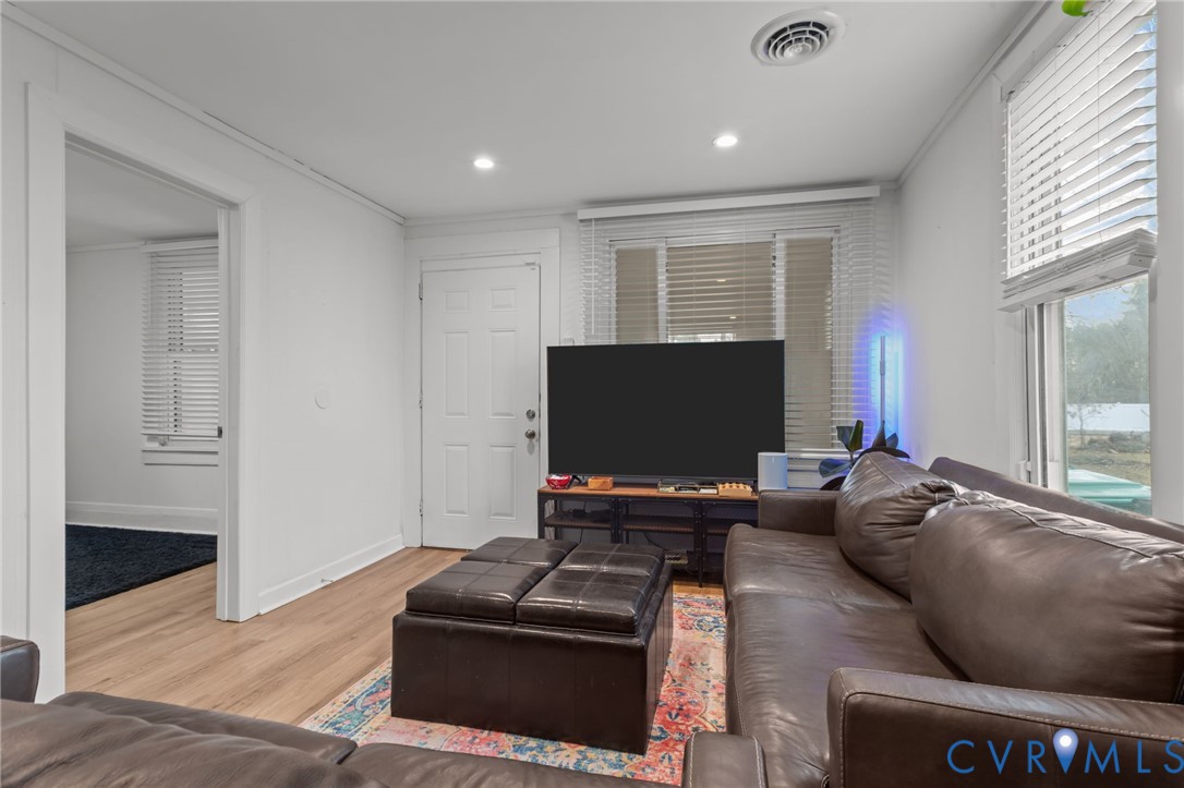 8874 Strath Road Henrico, VA 23231 - Photo 10 of 40 a living room with furniture and a flat screen tv