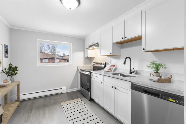 a kitchen with sink and cabinets