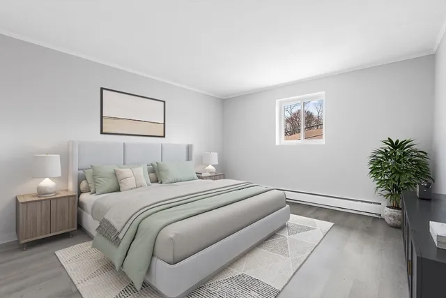 a bedroom with a bed and a potted plant