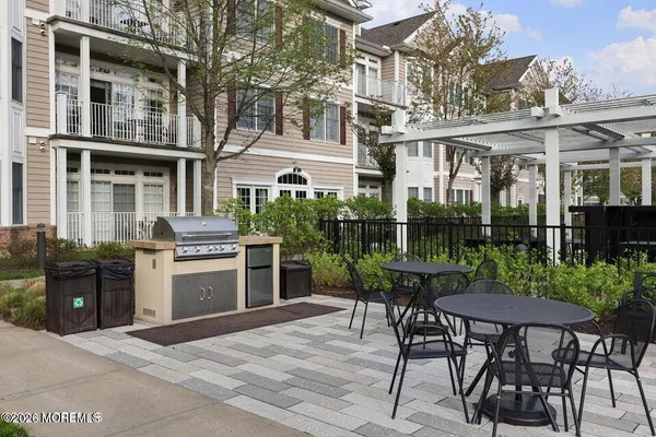 a view of a patio with table and chairs and potted plants