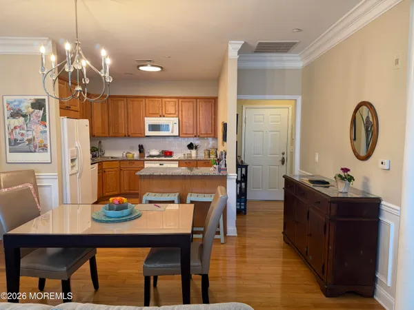 a open dining room with stainless steel appliances kitchen island a table and chairs