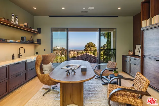 a living room with furniture and a projector screen