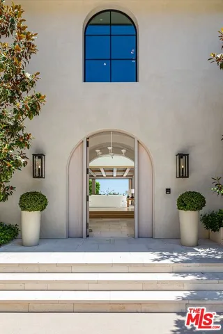 a living room with fireplace furniture and a potted plant