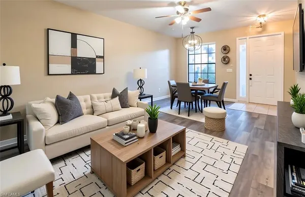 a living room with furniture a chandelier and a table