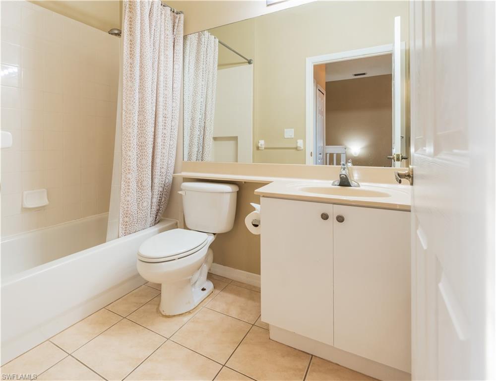 14751 Pinnacle Place, Unit 343 Naples, FL 34119 - Photo 14 of 24 Full bath with vanity, shower / bath combo with shower curtain, and light tile patterned floors