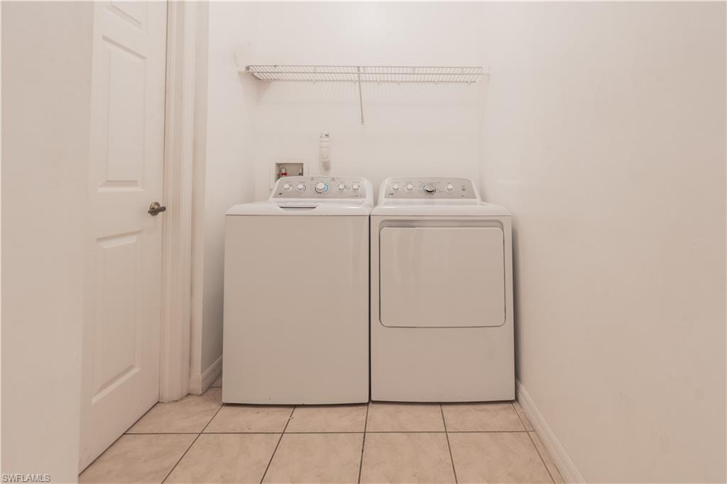 14751 Pinnacle Place, Unit 343 Naples, FL 34119 - Photo 15 of 24 Laundry area featuring light tile patterned flooring and independent washer and dryer