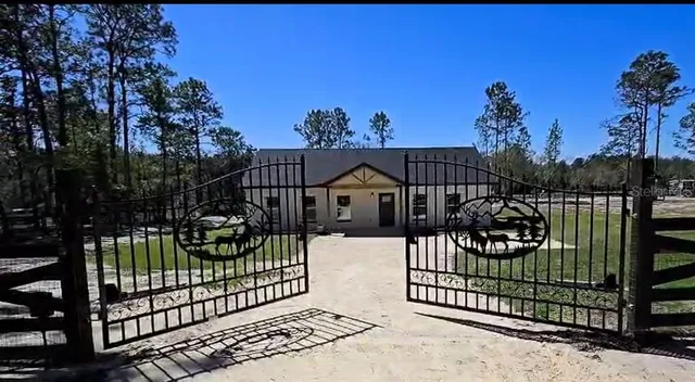 a view of a house with a wooden fence