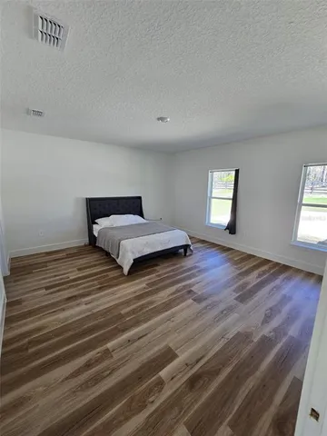 a room with a bed and window